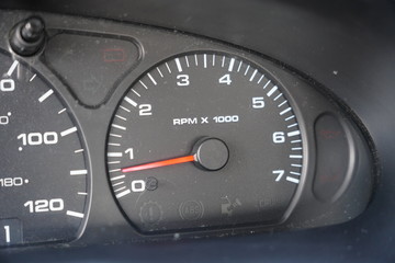 Fuel gauge, vehicle engine temperature, Miles Per Hour Speed indicator, and revolutions per minute indicator on a vehicle dashboard