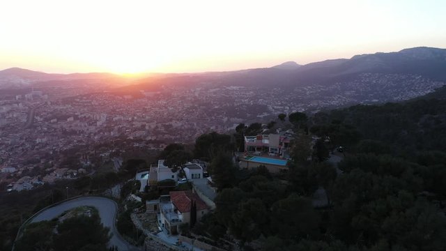Sunset aerial shot over Toulon luxurious villa hilltop pine forest France french riviera 