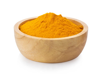 turmeric powder in wood bowl on white background