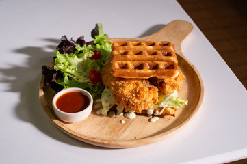 waffles stick with fish stick on wooden table