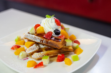 waffles stick with fruit on wooden table