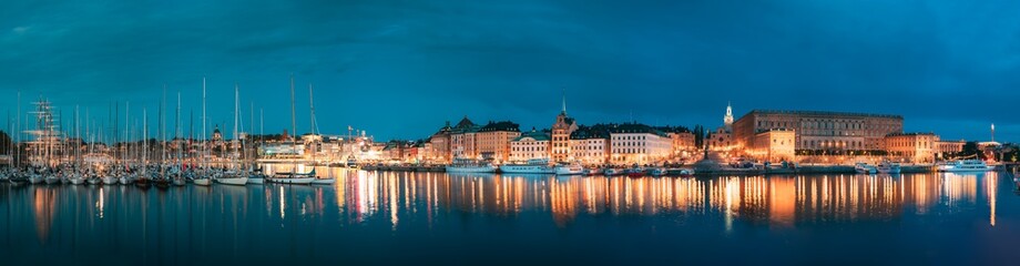 Stockholm, Sweden. Scenic Famous View Of Embankment In Old Town Of Stockholm In Night Lights. Gamla Stan, Great Church And Royal Palace. Popular Destination Scenic Place In Lights. Panorama