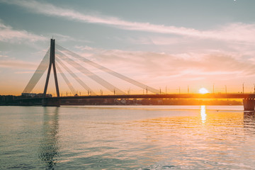 Obraz premium Riga, Latvia. Vansu Cable-Stayed Bridge Over The Daugava River, Western Dvina In Bright Sunset Or Sunrise Time