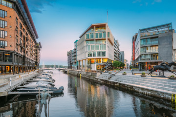 Obraz premium Oslo, Norway. View Of Residential Multi-storey Houses In Aker Brygge District In Summer Evening. Famous And Popular Place. Pier Jetty With Boats.