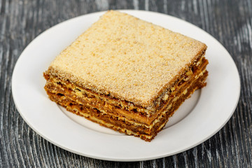 Honey cake with layers of tender dough and cream of condensed milk. Exquisite Russian dessert
