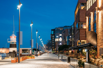Oslo, Norway. Night View Embankment And Residential Multi-storey Houses In Aker Brygge District. Summer Evening. Residential Area Reflected In Sea Waters. Famous And Popular Place - obrazy, fototapety, plakaty