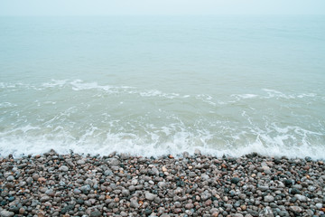 French coastline of Normandy in France with pebbles beaches, part of the typical landscape 