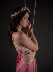 Fototapeta premium young girl on swing with romantic dress and renaissance atmosphere