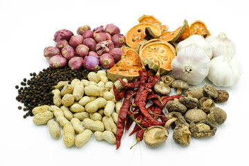 Group of dried herbs and spices on white background.