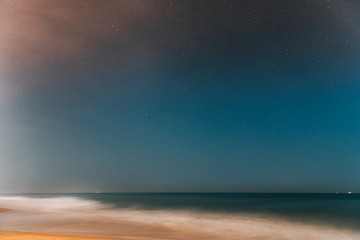 Naklejka na ściany i meble Goa, India. Real Night Sky Stars. Natural Starry Sky In Blue Color Above Indian Ocean Sea Seascape Beach Copast. Background