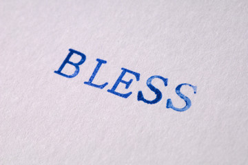 a bless word stamped on a piece of paper.