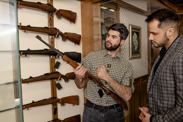 confident and affable salesman, consultant give good rifle, gun for hunting to look. customer want...