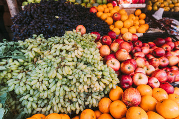 Fresh Ripe Fruits At A Farmers Market. Grapes, Apple, Oranges