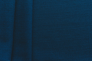 Jute blue linen on a table in natural light, folded