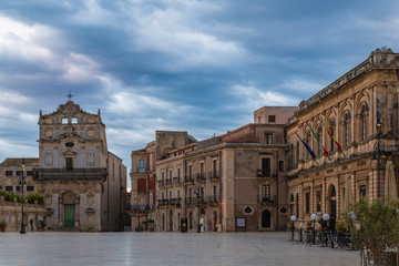 Fototapeta premium Main square of Ortygia island and view of the catholic church of Saint Lucia alla Badia at sunrise in province of Syracuse in Sicily