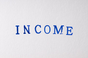 a income word stamped on a piece of paper.