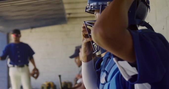 Baseball player putting on his equipment