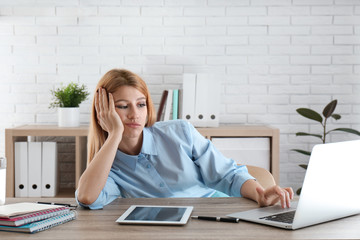 Lazy employee wasting time at table in office