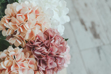 Beautiful bouquet of multi-colored hydrangeas on a light wooden floor. Spring background. Father`s Day, Easter, Happy Women's Day, Mother's day. Flat lay, top view, copy space