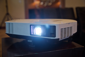LCD video projector at business conference or lecture in office with copy space. projector on...