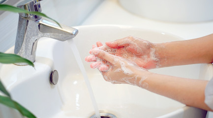 Hygiene concept Wash your hands with soap in the sink.Cover for virus protection.