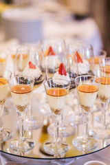 Sweet dessert in small glasses on a buffet table