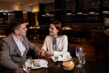 young caucasian couple celebrate anniversary in restaurant. happy man and woman in love. couple enjoy dinner in luxury place. love, relationships, anniversary, holidays concept