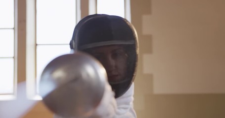 Female fencer athlete during a fencing training in a gym - Powered by Adobe