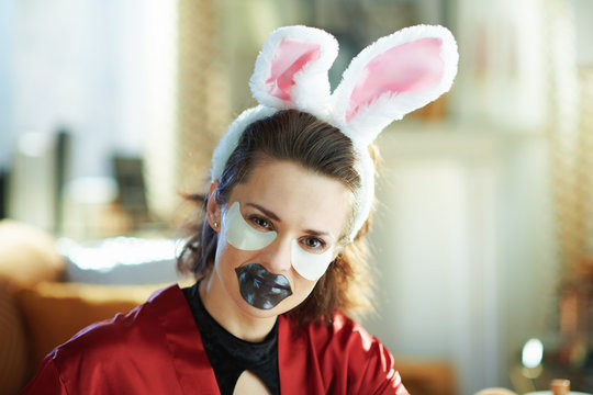 woman with bunny ears making cosmetic lip mask and eye mask