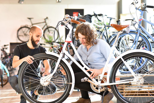 customer and dealer in bicycle shop - purchase and repair of bicycles - customer service