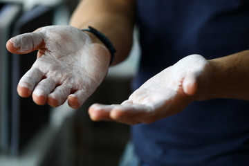 Male hands smeared with magnesium powder ready to workout - obrazy, fototapety, plakaty