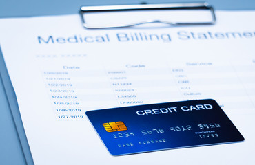 top view picture of medical billing statement, cradit card  on the gray background