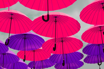 Colorful umbrellas flying across the sky. Colorful umbrellas background. Street decoration