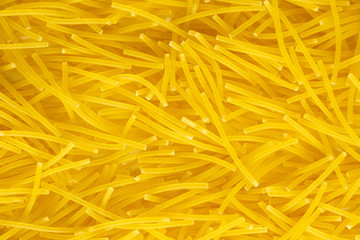 close up of an italian macaroni paste food background. yellow macaroni products macro. Top view. Texture, place for text.