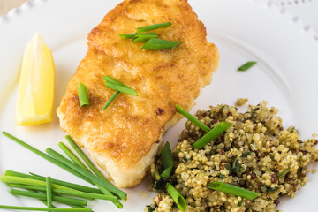 Fried light breaded cod fish.