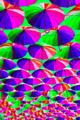 Fototapeta na wymiar Colorful umbrellas background. Colorful umbrellas in the sky. Street decoration