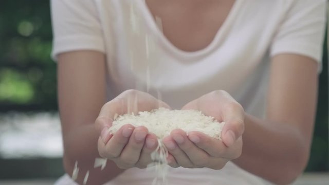 4k selective focus high nutrition white rice drop on kid hand movement