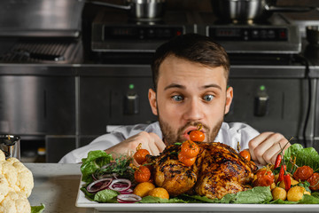 funny surprised caucasian chef-cooker in kitchen. professional cook look at beautifully decorated...