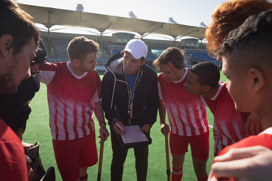 Field hockey players arm in arm before the match