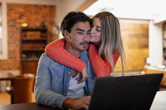 Young couple looking at the laptop together