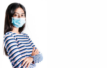 young woman in medical face protection mask indoors on blue background