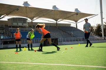 Female hockey players training on the field
