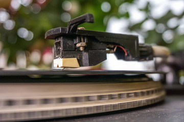 Fototapeta na wymiar vinyl record. retro look whirling vinyl record player. close up selective focus