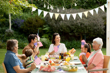Family eating outside together in summer