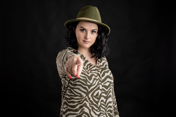 Attractive young woman dressed casually pointing her finger
