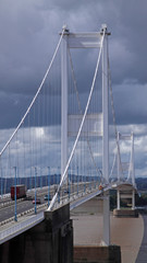 Storm clouds brewing over the origninal road bridge across the river Severn between England and Wales