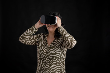 Attractive young woman dressed casually hands on VR glasses, virtual reality