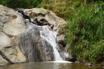 Scenic view on a small waterfall in the jungle. Pai, Thailand.