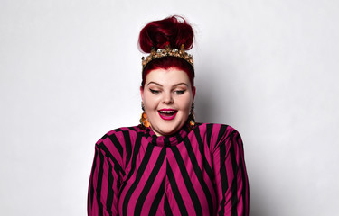 Chubby redhead woman in a black and purple striped dress, crown and earrings. She looks down and is very surprised at something. Suitable for advertising and banner