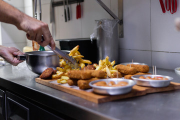unrecognizable chef preparing frying board